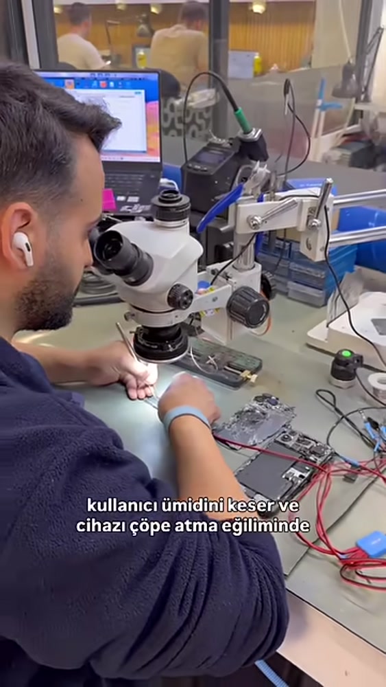 Fppro teknisyeninin hasarlı iPhone değerlendirmesinde mikroskopla çalışması