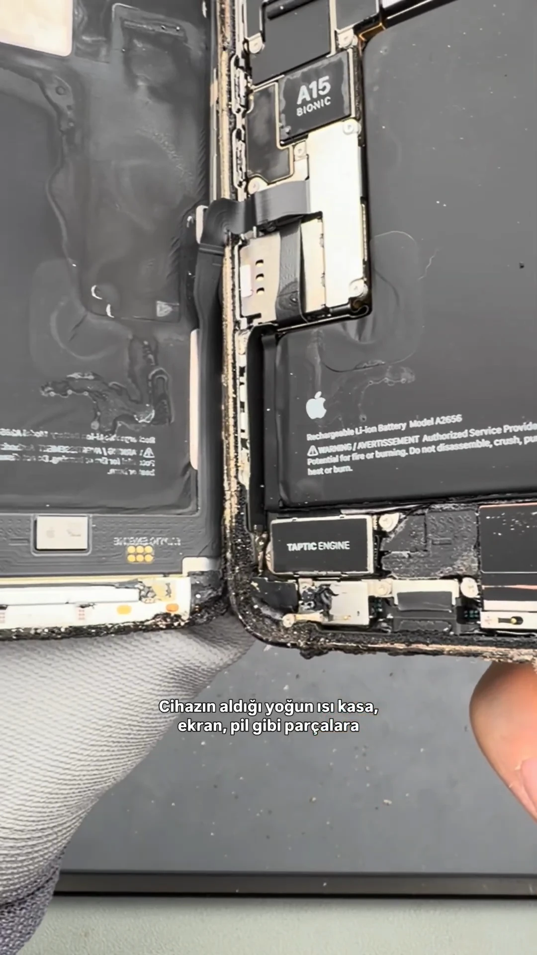 Yanan iPhone 13 Pro açıldıktan sonra ekran, pil ve anakartın görünümü